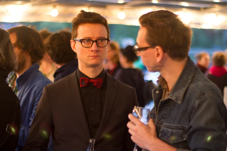 two men in business attire standing next to each other