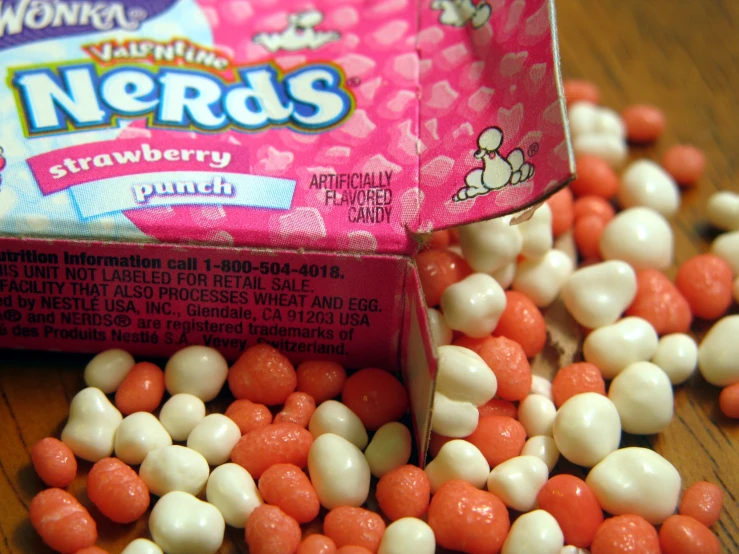 candy and marshmallows are sitting on a wooden surface