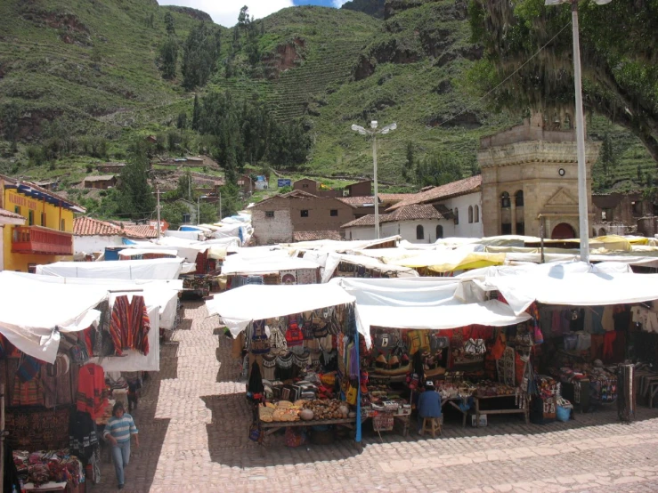 an outdoor market set up on a stone street