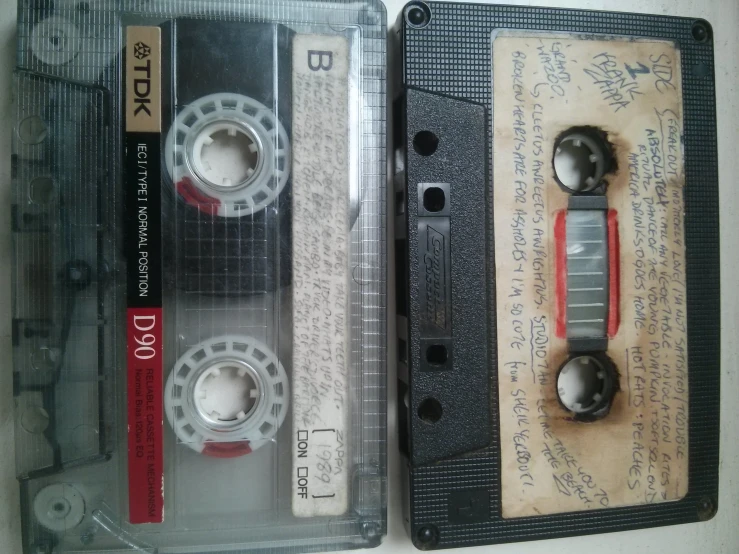 an old pair of black and white audio tape cassettes