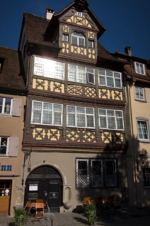 an old building with several windows and an ornate wooden frame