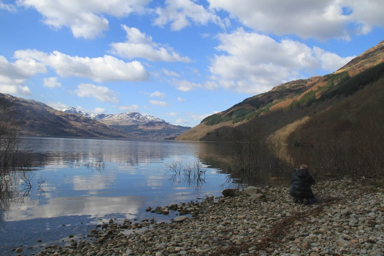 a large body of water with mountains in the background