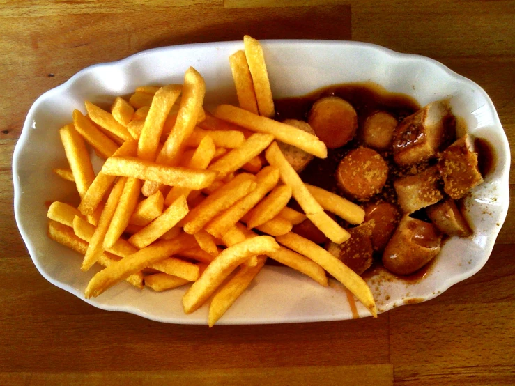 fried potatoes and french fries sit on the table