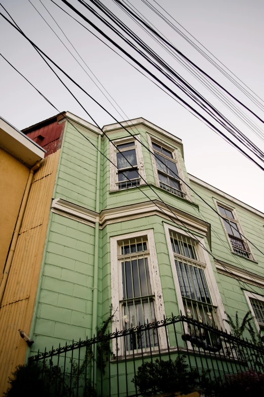 the view of an old house with power lines above it