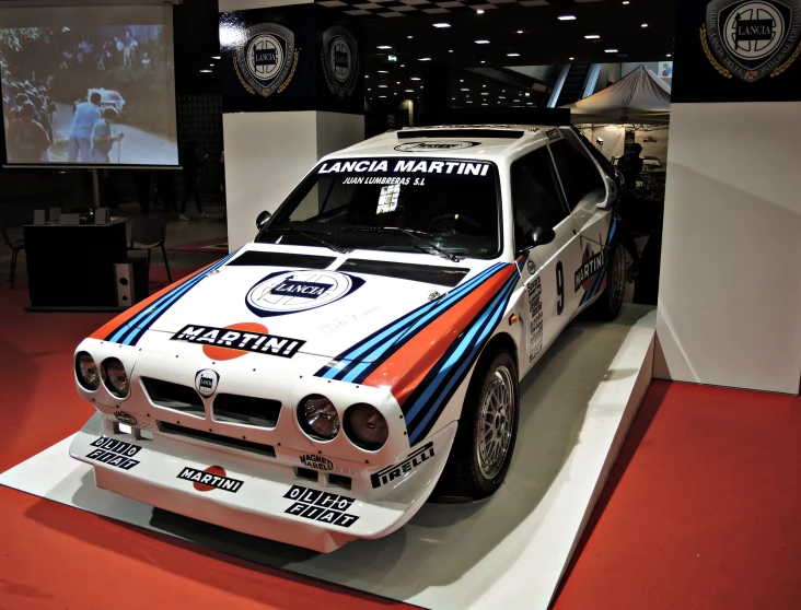 a modified racing car on display at an auto show