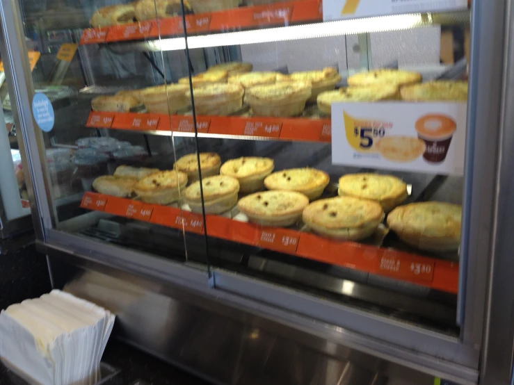 an assortment of pastries on display in a display case