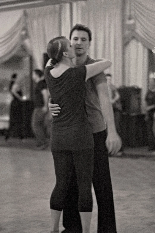 two people dance together in an empty ballroom