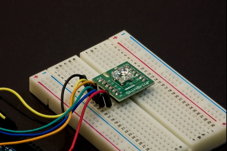 an electronic circuit board and colored wires on the edge