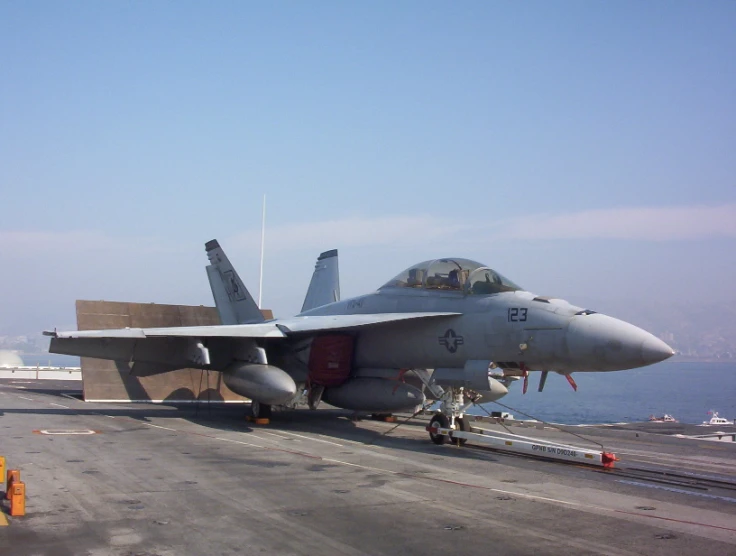an jet is on the flight deck of a aircraft carrier