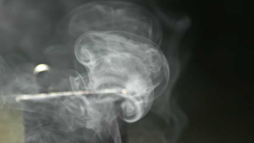 a metal item is covered with smoke as it is lit