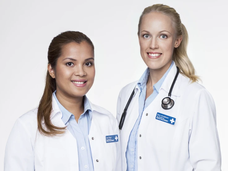 two women in white lab coats with a stethoscope on their neck