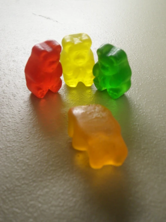 three gummy bears are lined up on a table