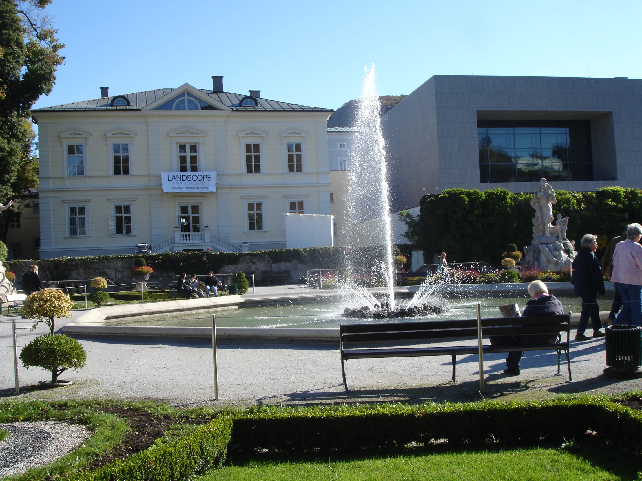 an image of people sitting by the water fountain