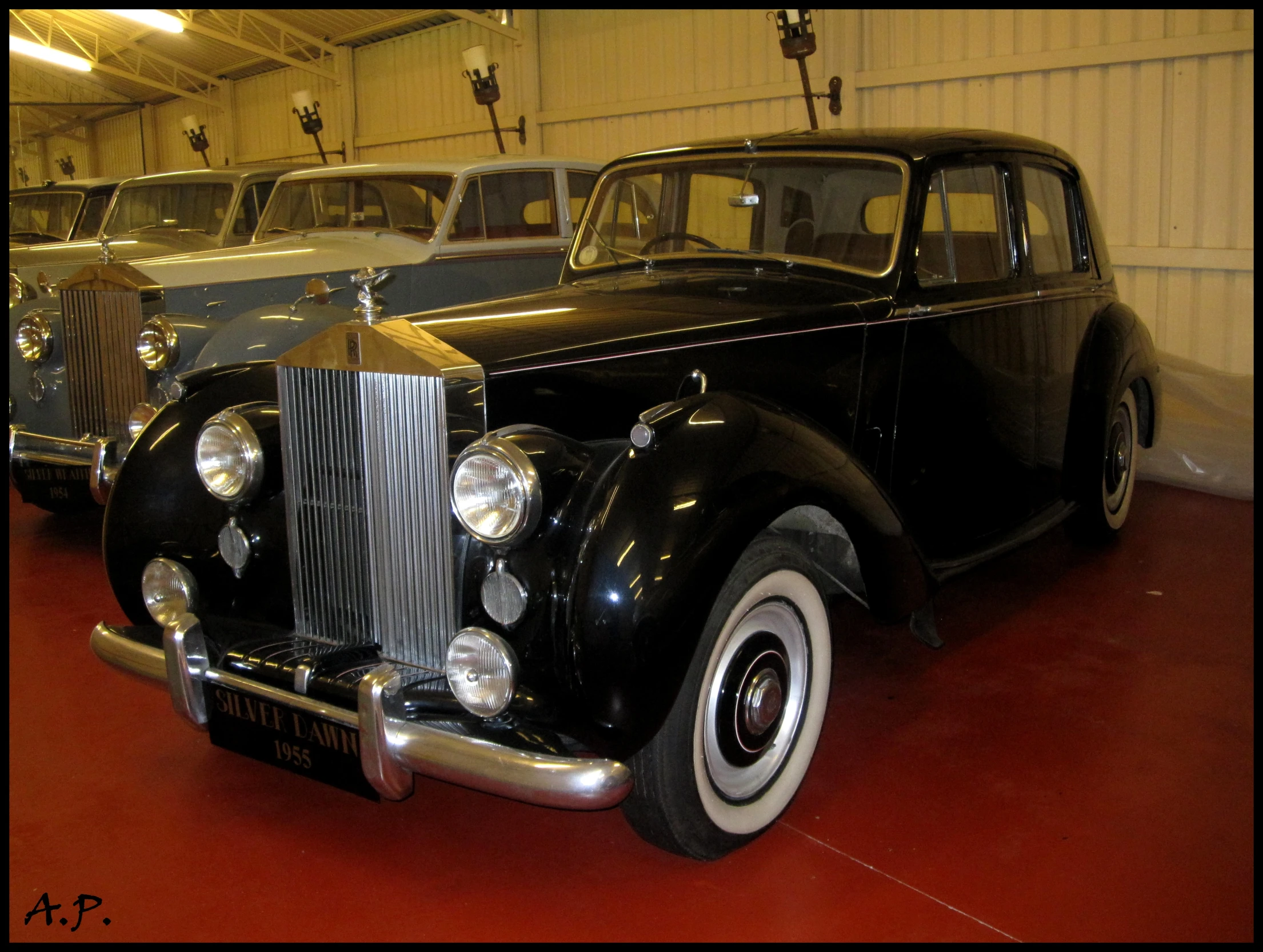 this is several classic cars in a garage