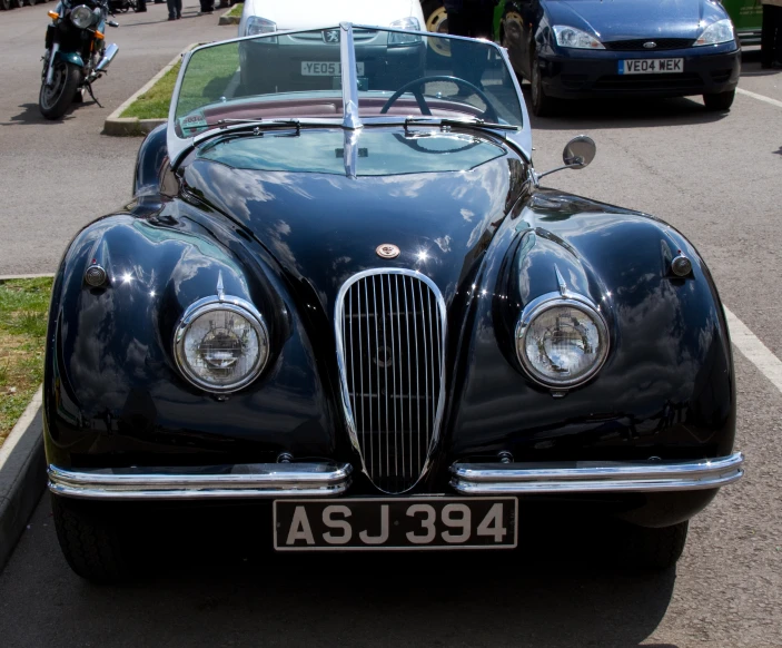 a car sits in a lot, awaiting for its owner to drive