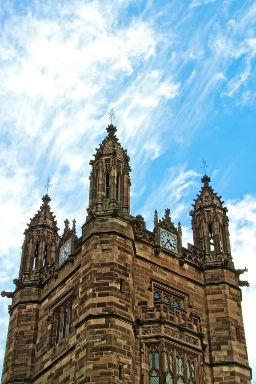 a large cathedral type building with two clocks on the tops