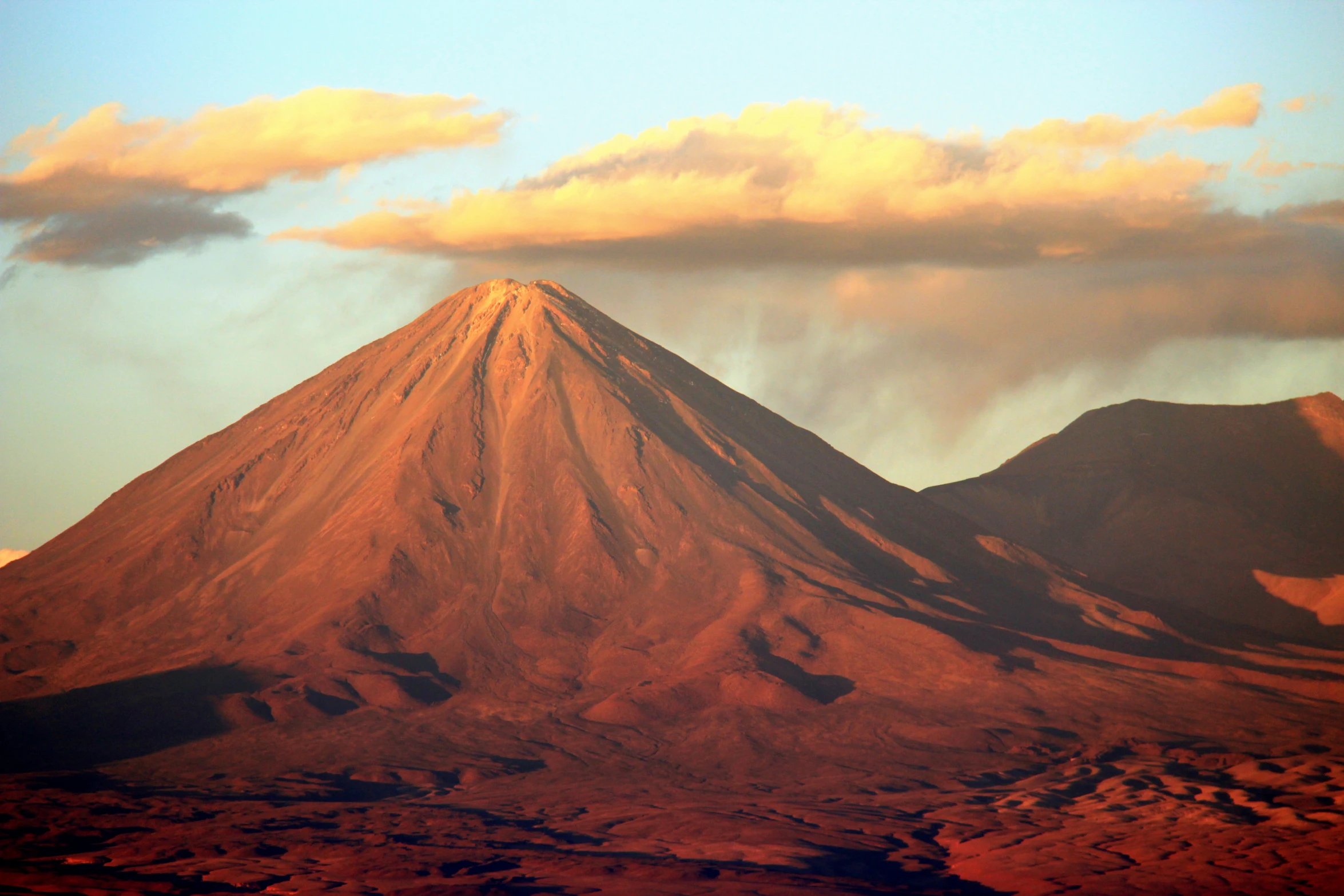 a mountain with some cloud formation at the top