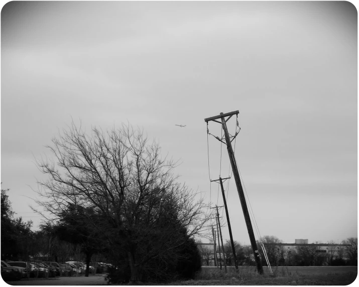 a tall pole and telephone towers in the background