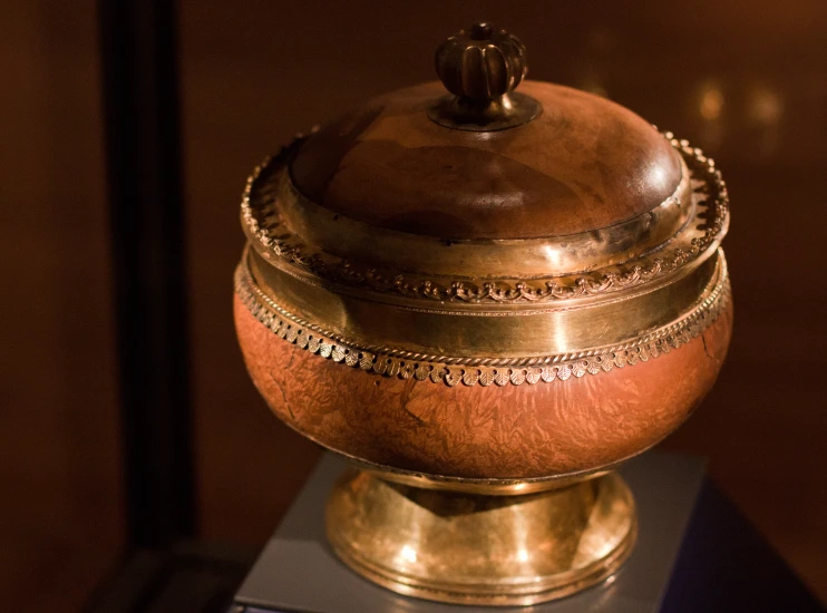 an antique wooden box sits on top of a stand