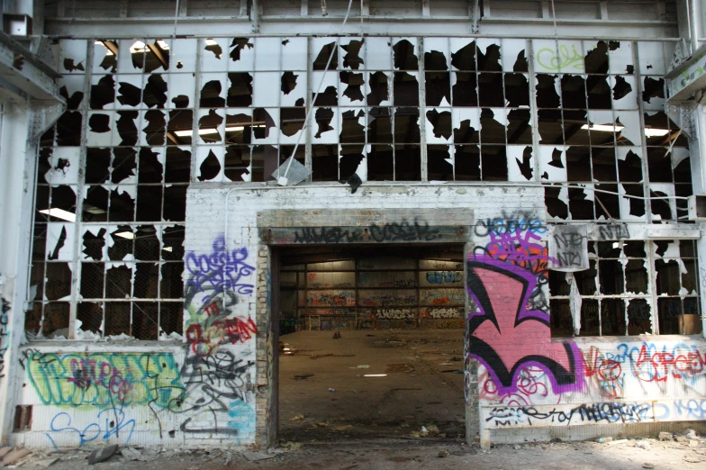 a building with graffiti all over it and multiple doors