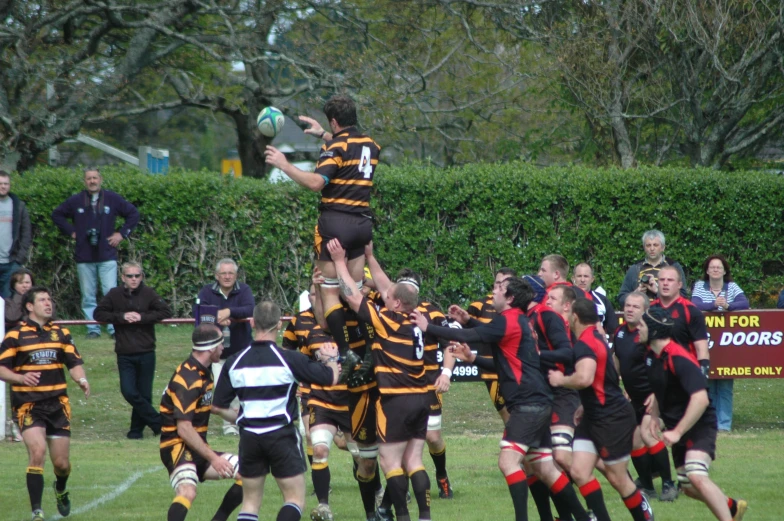 some rugby players are playing rugby in a field