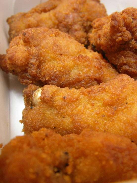 three fried food items in a paper container