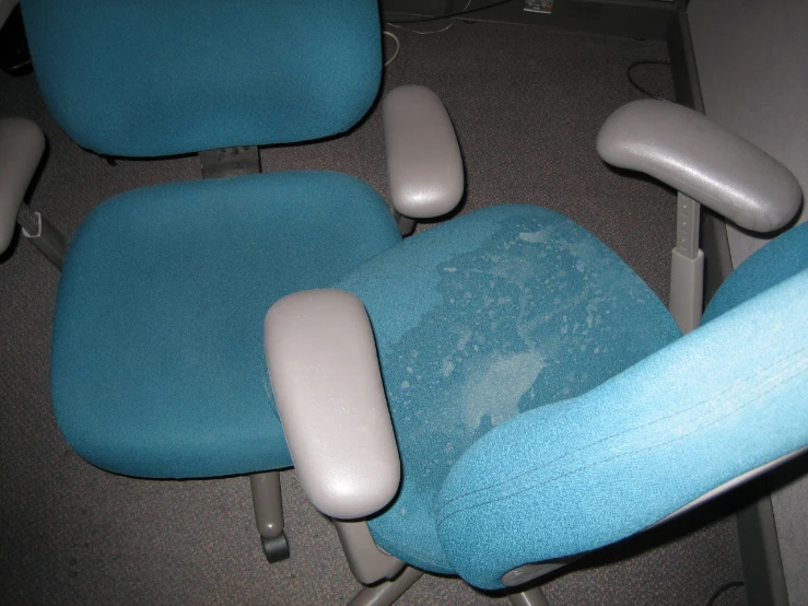blue chair with white cushions that are slightly damaged