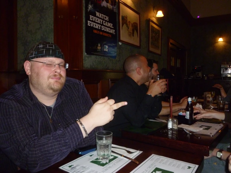 a group of people sitting around a bar