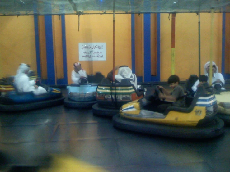 some people riding in bumper boats in a mall