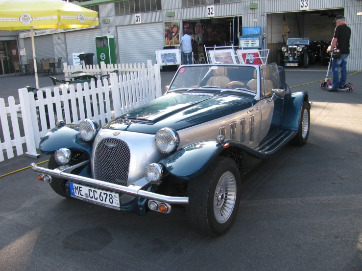 a old model car parked on the side of the road