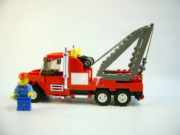 a toy truck with a small fireman in the back