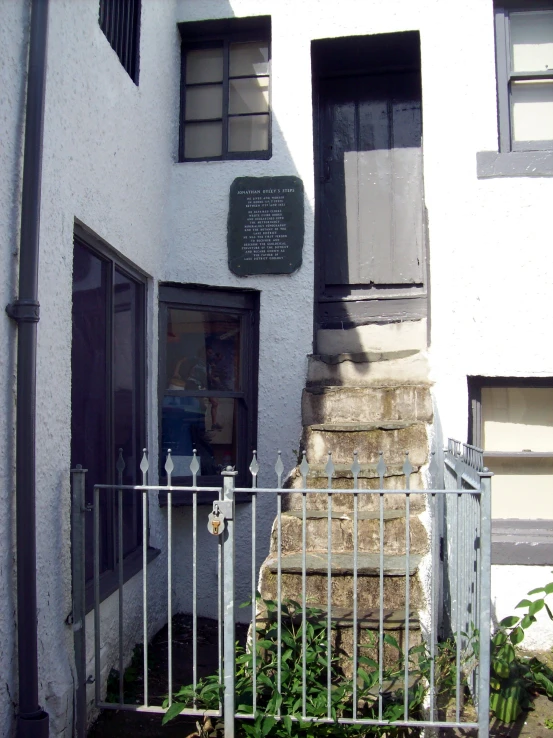 an old gated building is in front of an entrance