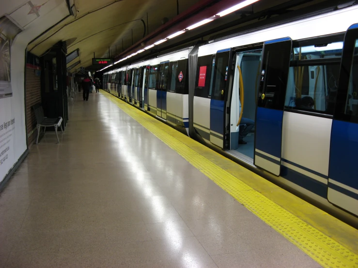 people are walking in line at the subway station