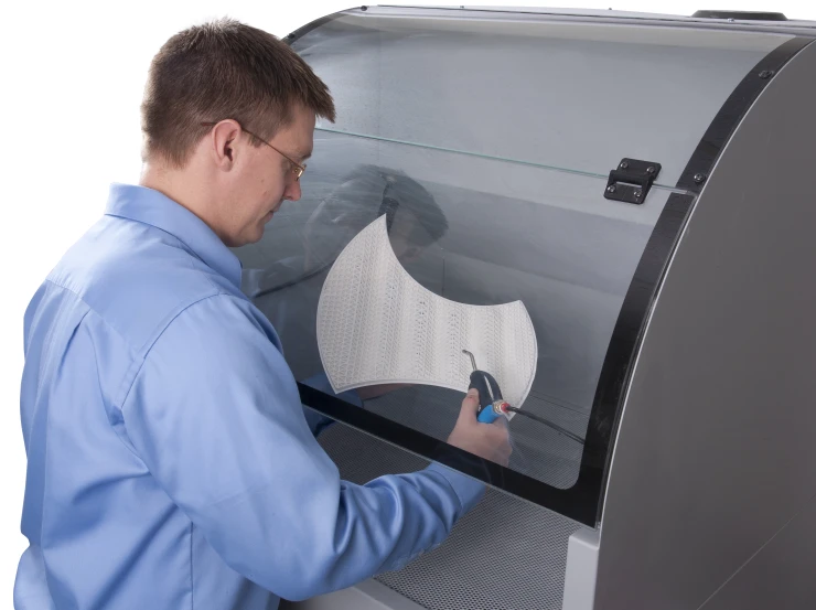 a man working on a car's window glass