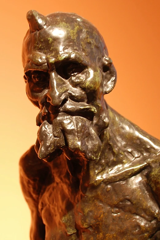 a bronze statue has a mean head and moustache