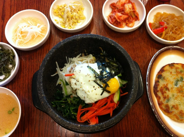 various foods are placed in bowls on the table