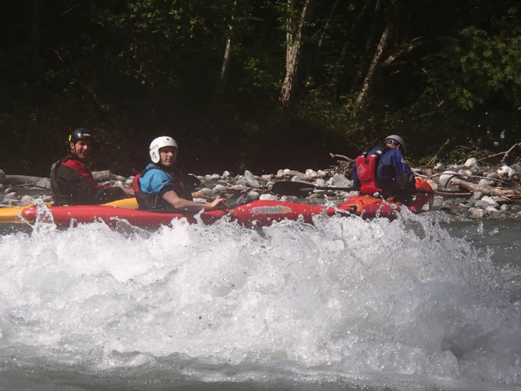 people are in the water with a kayak