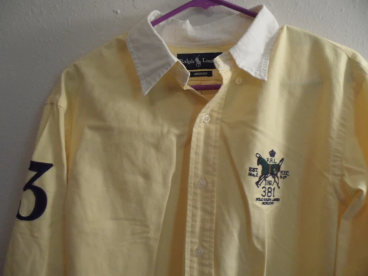 there is a yellow shirt that has a logo on it