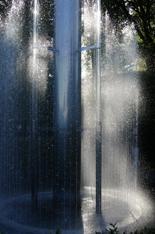 a fountain spraying water in a park setting
