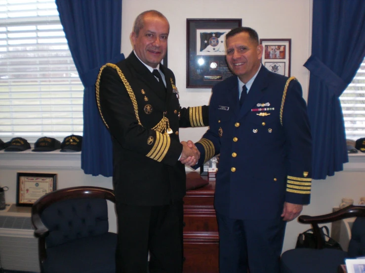 a couple of men in military uniforms shaking hands