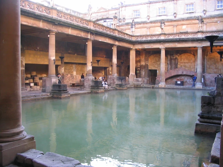 two people are near a body of water that is in an underground space