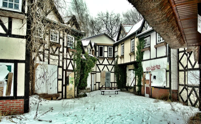 a view of a street with houses and trees covered in snow