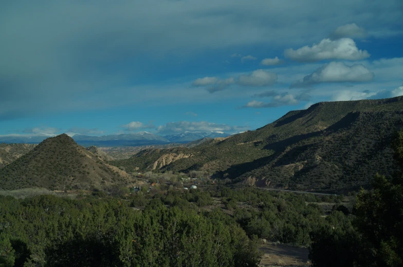 a scenic mountain range in the desert under a cloudy sky