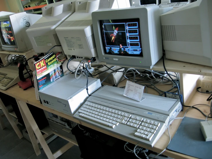 a row of video games on top of a computer desk