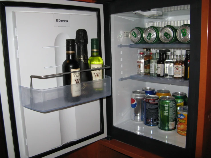 there is a mini fridge with a lot of beer