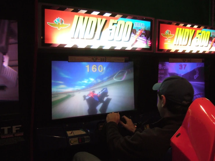 man playing games in a darkened arena