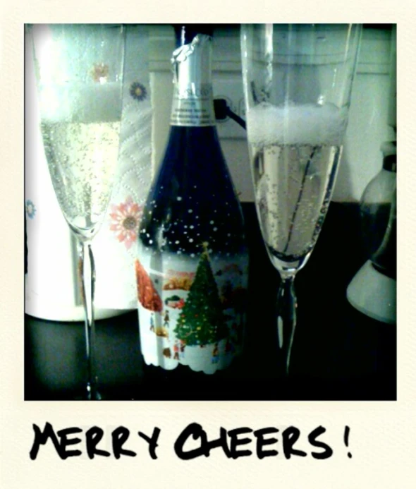 a christmas card showing two champagne flutes and bottles