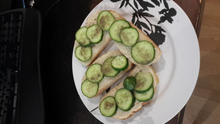 sliced cucumbers are on a sandwich on a plate