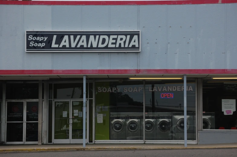 a store front with two front washers and laundry machines