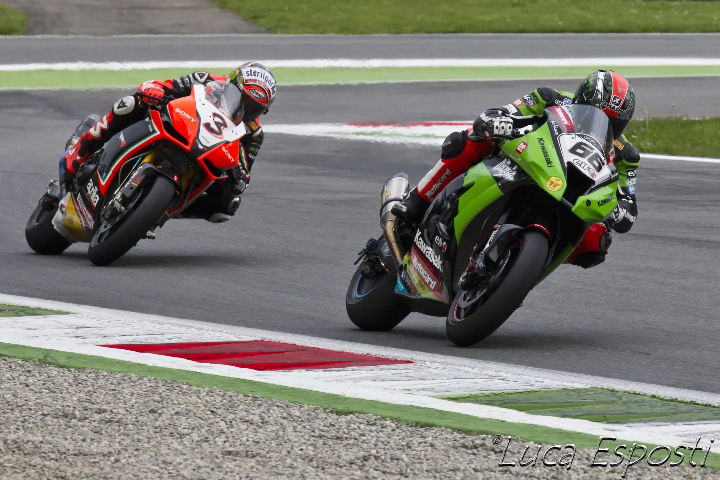 two motorcycles racing on an open race track